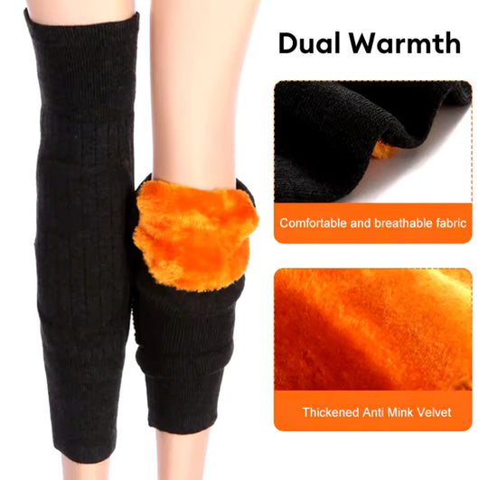 Black leg warmers with orange cuffs worn by a person, showing comfort and breathability features.